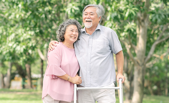 asian-senior-couple-talking-walk-with-walker-park